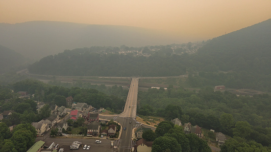 Wildfire smog covers Stg Andrew Memorial Bridge across Lehigh River in Jim Thorpe (Mauch Chunk) of Appalachian Mountains, Poconos, Pennsylvania