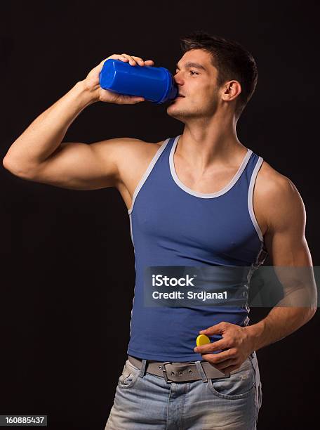 Muscular Man Drinking Protein Shake Stock Photo - Download Image Now - 20-29 Years, Adult, Black Background