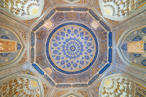 View of ceiling in the Shah-i-Zinda Ensemble in Samarkand, Uzbekistan. Ceiling decorated by blue tiles with designs. The necropolis is a popular tourist attraction of Central Asia.