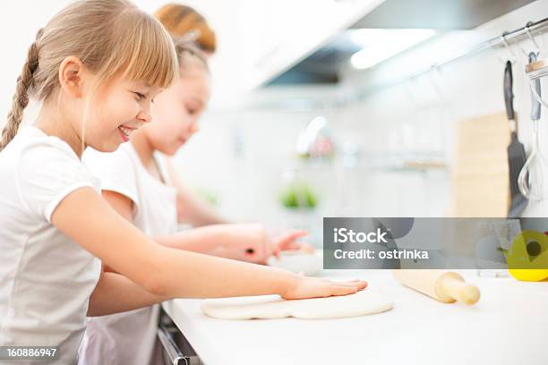 Happy Mother And Daughters Smiling Stock Photo - Download Image Now - Baking, Child, Dinner