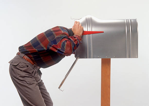 man with head in mailbox stock photo