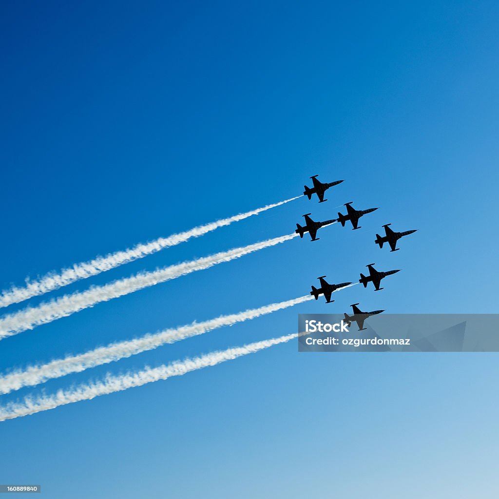 Fighter planes in airshow on blue sky Square composition of seven fighter planes with smoke in airshow. Clear blue sky with copy space. Image taken with Hasselblad H3D Camera System and developed from RAW. Fighter Plane Stock Photo