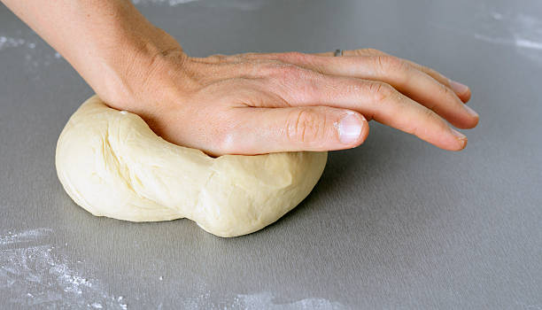 Kneading dough Male kneading dough in domestic Kitchen. hott stock pictures, royalty-free photos & images