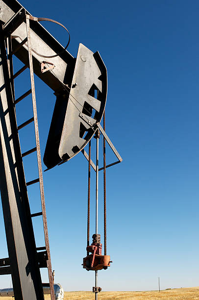Pumping Oil A pump jack on the Canadian oil field in Alberta oilsands stock pictures, royalty-free photos & images