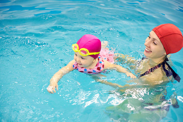 baby swimming stock photo