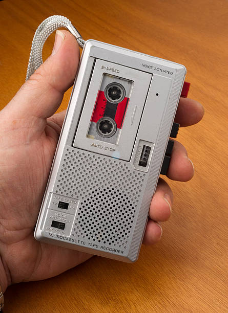 Hand on Audio Recorder using Tape the Old Fashioned Way Male Hand Holds Audio Recorder using Tape for documenting sound vintage portable silver radio stock pictures, royalty-free photos & images