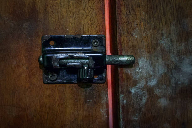 istock A slot lock on a wooden door. 1608944990