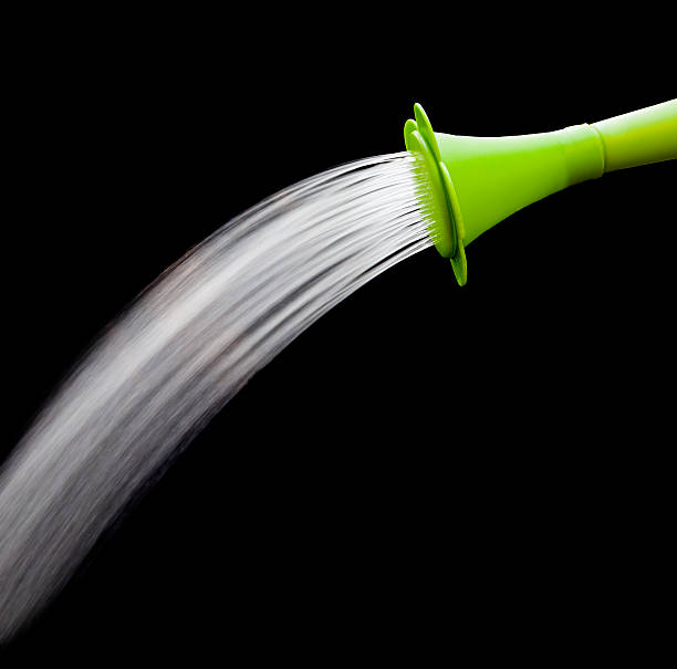 istock green watering can pouring water with slow speed shutter 160895253