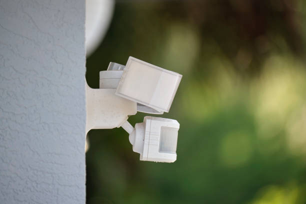 istock Motion sensor with light detector mounted on exterior wall of private house as part of security system 1608961000