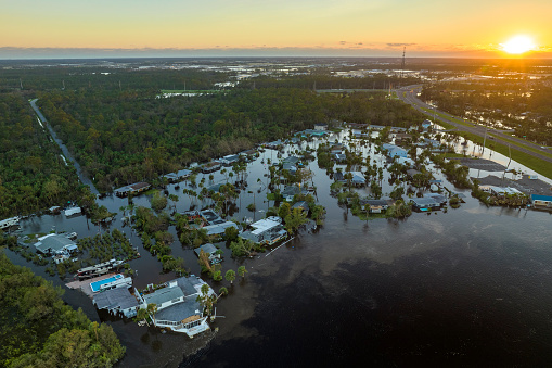 Surrounded by hurricane Ian rainfall flood waters homes in Florida residential area. Aftermath of natural disaster.