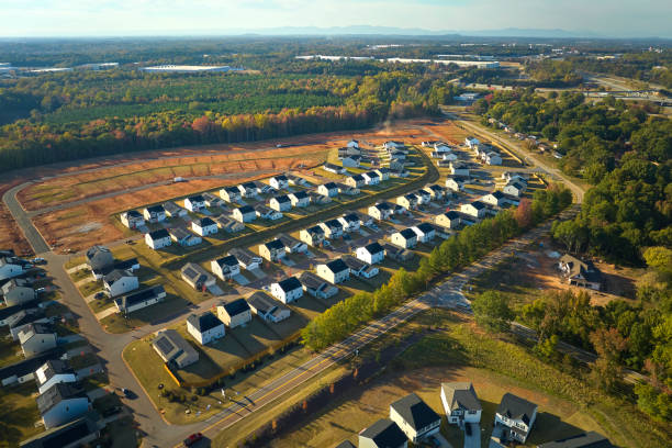 Ground prepared for building of new residential houses in South Carolina suburban development area. Concept of growing american suburbs Ground prepared for building of new residential houses in South Carolina suburban development area. Concept of growing american suburbs. basement construction site construction blueprint stock pictures, royalty-free photos & images