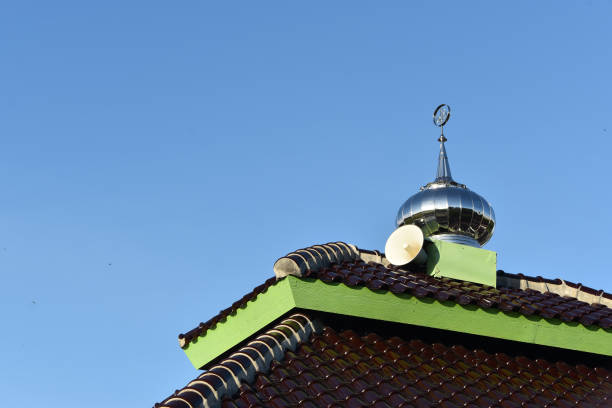 istock Mosque roof with small chromed dome against clear blue sky 1609021667
