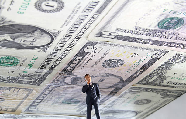 Debt Ceiling Political figure standing under a ceiling made of US money. debt ceiling stock pictures, royalty-free photos & images