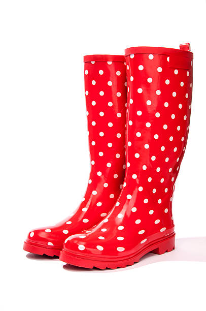 Red gumboots with white polka dots Red gumboots with white polka dots facing at an angle together red boot stock pictures, royalty-free photos & images