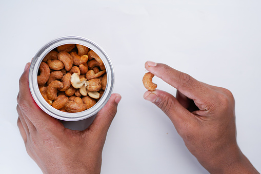 close up of almond nuts on man's hand .