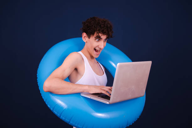 Student posing on a blue background.