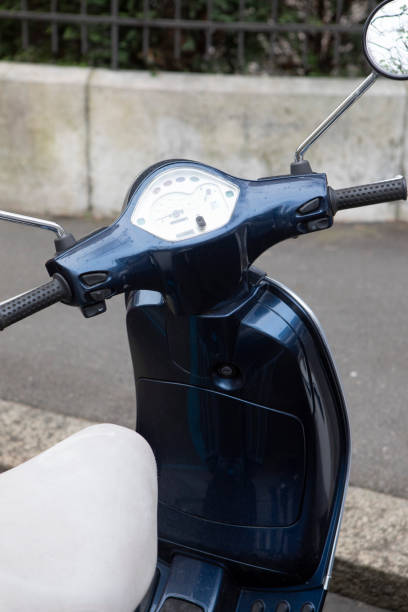 istock Motor scooter parked by a pavement 1609037755