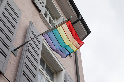 Low angle view of a rainbow flag outside a traditional building in Basel