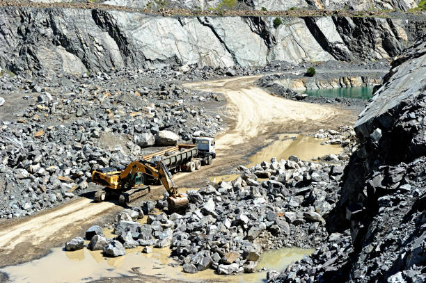 A large truck being loaded with rocks at an open pit gravel mine in Cape Town, South Africa