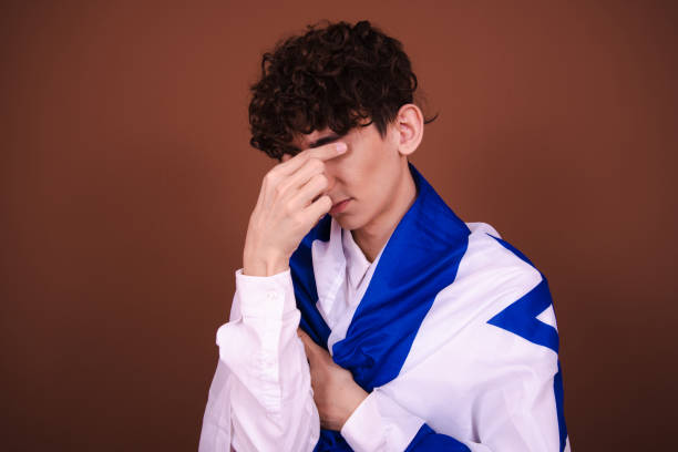 istock Attractive guy posing with the Israeli flag on a brown background. 1609050236
