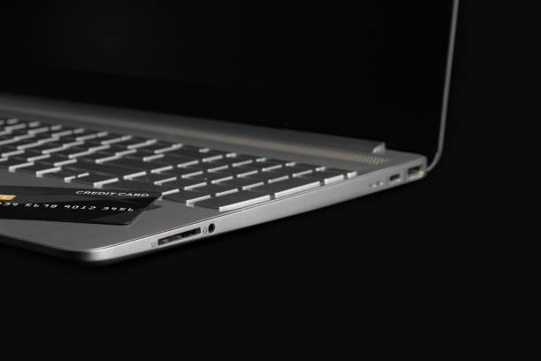 istock Laptop with credit card on black background. 3d rendering. 1609067314