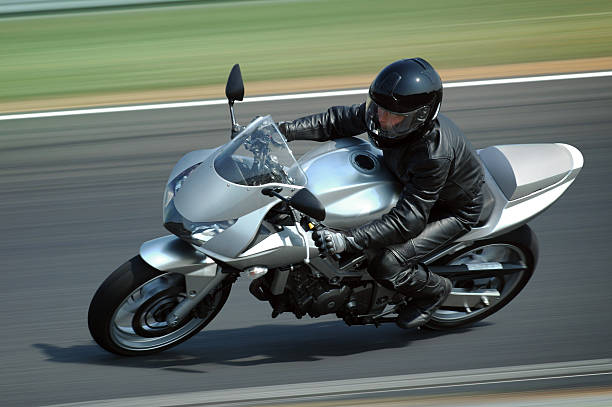 Silver motorcycle Woman rading on very fast motorcycle  motorcycle racing stock pictures, royalty-free photos & images