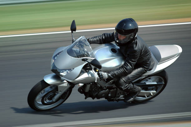 Silver motorcycle Woman rading on very fast motorcycle  motorbike racing stock pictures, royalty-free photos & images