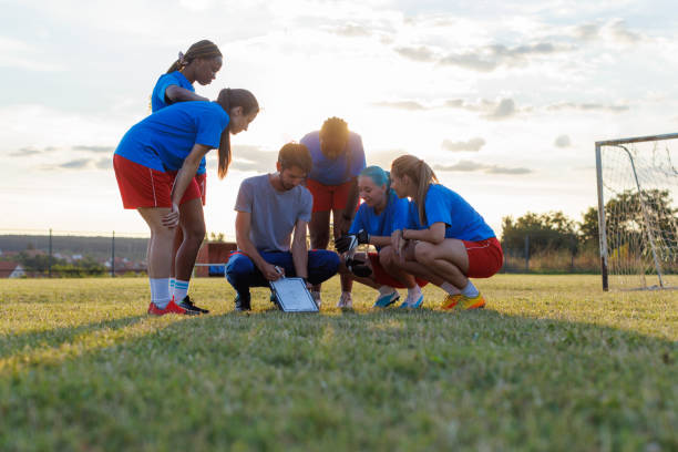 istock Women's Soccer Team Talking With Their Coach On Training 1609120674
