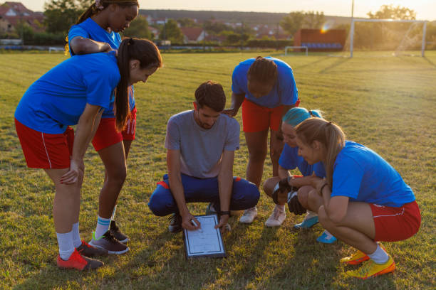 istock Women's Soccer Team Talking With Their Coach On Training 1609121196