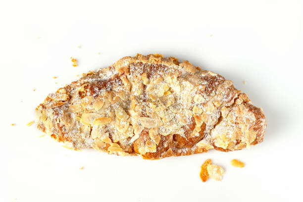 istock one almond croissant with crumbs on a white background 1609146382