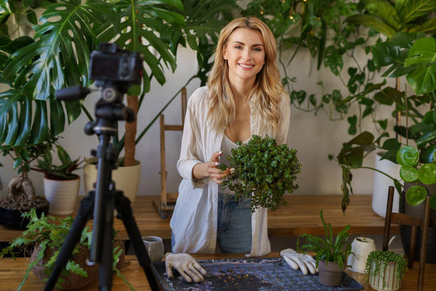 istock Florist blogger capturing her plant care routine in room with vibrant greenery 1609149062