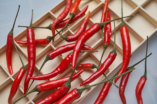 Red chili peppers on the wooden tray