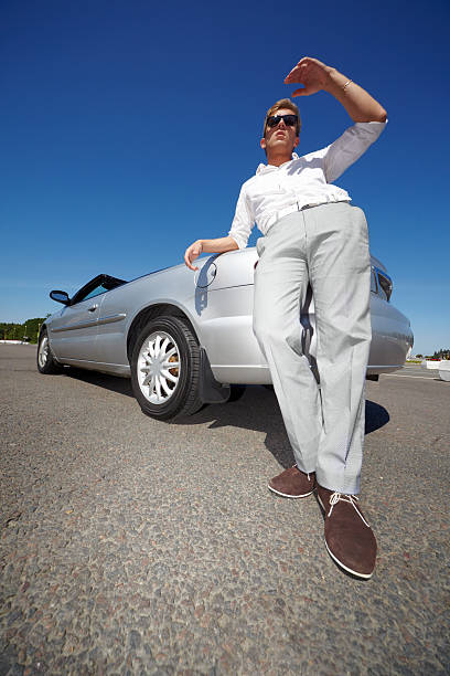 istock Man stands leaning on trunk of car 160918609