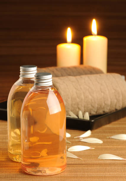 Spa concepts with body oils, candles, towels and petals