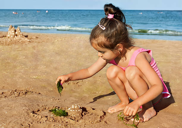 Little girl playing on the seaside
