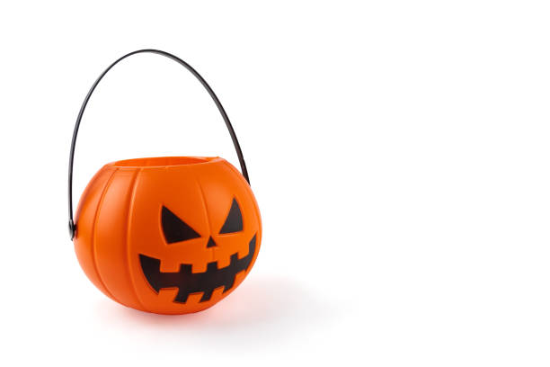 istock Halloween Candy Harvest: Pumpkin Basket on White Background for Trick-or-Treating 1609270874