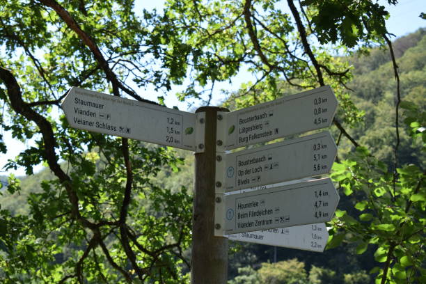 hiking sign Vianden, Luxembourg - 08 10 2023:hiking sign  to many place in Our Valley vianden stock pictures, royalty-free photos & images