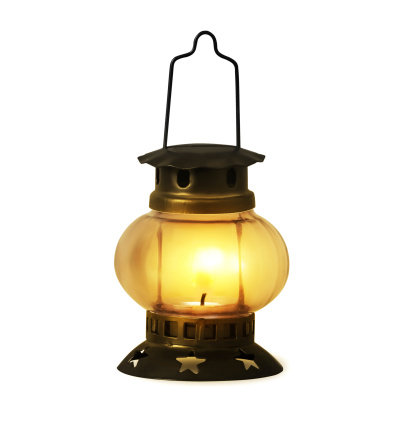 Old kerosene lantern burning with bright flame
