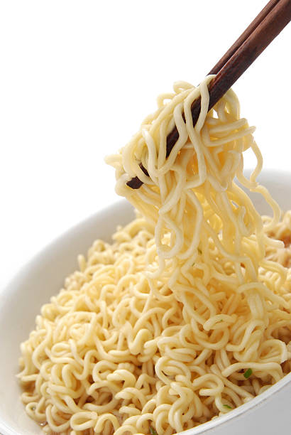 istock chopsticks holding oriental noodles on white 160933239