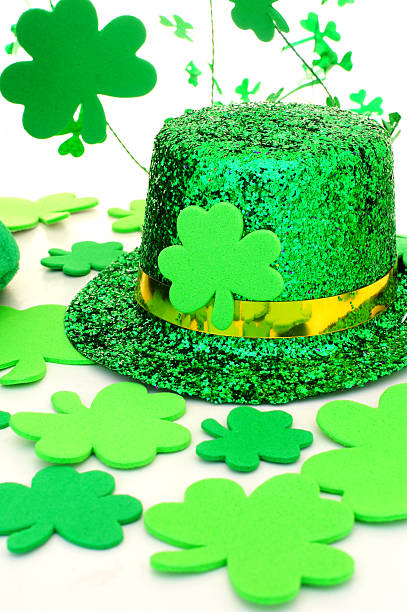 istock St Patricks Day hat with shamrocks over white 160934857
