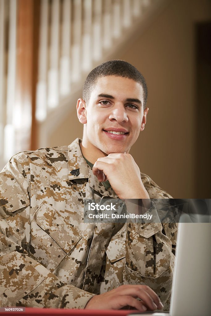 US Marine Corps Solider Working on Laptop US Marine Corps soldier working on laptop. The model is wearing an official US Marine corps Marpat BDU uniform. Portrait Stock Photo