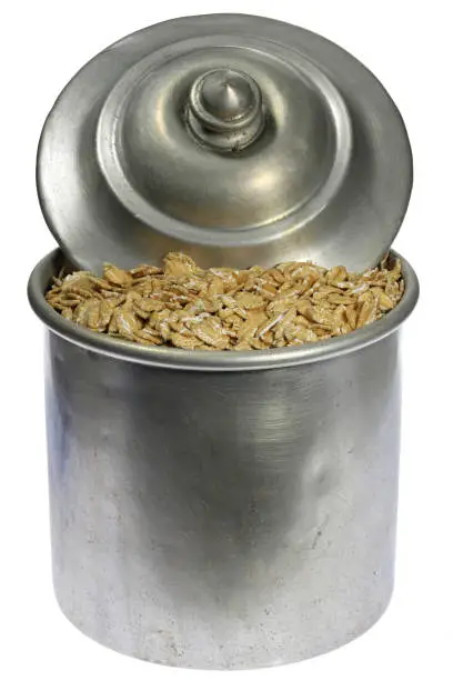 Photo of spelt flakes in an aluminum jar