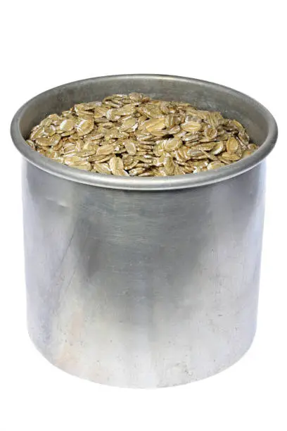 Photo of rye flakes in an aluminum jar