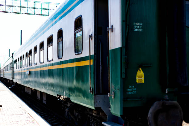 The wagons of a train in Uzbekistan photographed during the day at a station.