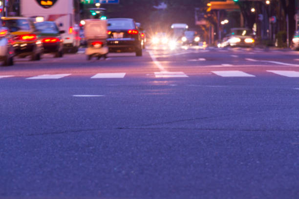 istock Crosswalk and blurred car tail lamps 1609400988