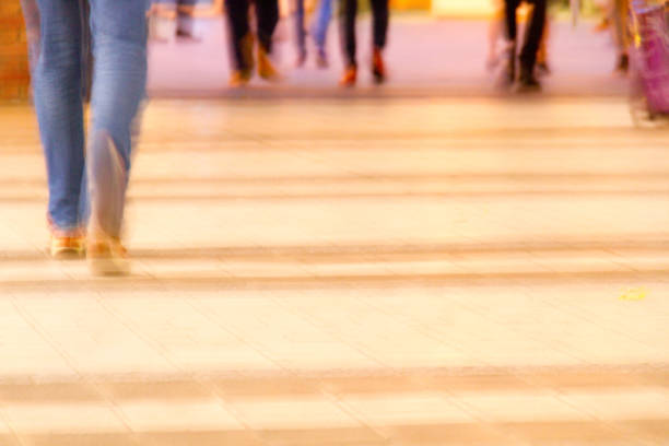 istock Blurred people in jeans walking on the sidewalk 1609401530