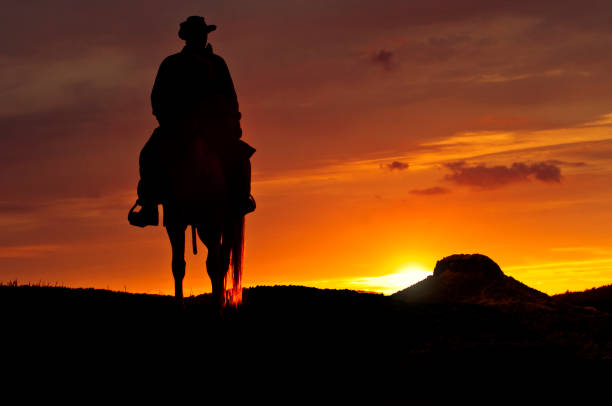 istock Cowboy rides into the sunset 160940201