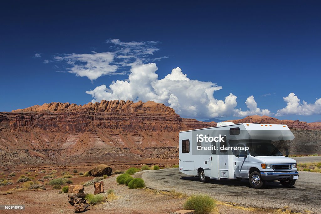 RV canyonlands white RV / campervan in canyonlands USA with red cliffs and blue sky behind it Motor Home Stock Photo