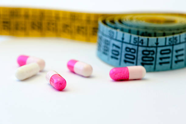 istock Diet - measuring tape and pills 160941901