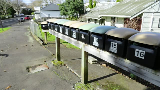 A whole row of mailboxes outside the house